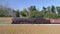 Strasburg, Pennsylvania, October 2019 - Aerial View of a  Antique Steam Engine Stopped at Station with Freight Cars Through Amish