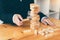 Strategic thinking and risk by business people pulls wooden blocks from the group