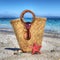 Straw bag, starfish and shell by the shore in hdr