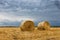 Straw bales on farmland Storm clouds.