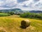 Straw bales on the field near Saschiz fortified church in Saschiz villages, Sibiu, Transylvania, Romania. Agriculture landscape, g