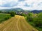 Straw bales on the field near Saschiz fortified church in Saschiz villages, Sibiu, Transylvania, Romania. Agriculture landscape, g