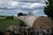 Straw bales piled up next to a stone wall