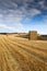 Straw Bales stacked in farm field at harvest time