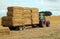 Straw bales, tractor and trailer.
