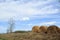 Straw bales under clouds