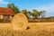 Straw ball on field in the Czech Republic. Harvested field. Morning on the far. Hay bales after harvest on the field. hay-roll on