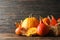 Straw basket, pumpkins, leaves and cinnamon on wooden background