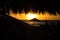 Straw beach roof in the cafe with blurred people on beautiful tropical sunset.