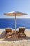 Straw beach umbrella and sunbeds on the west coast of Zakynthos island, Greece