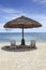 Straw Beach Umbrella with White Beach Chairs on Micro Beach in Saipan