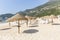 Straw Beach Umbrellas and sun loungers on Portinho da Arrabida Beach