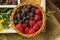 Straw box of fresh seasonal summer berries