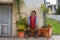 Straw doll farmer sitting in front of a farmhouse, harvest celebration, decorations in Austria