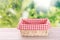 Straw empty basket decorated with picnic checkered cloth  nature background