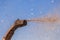 Straw flying from a harvester, close-up against the sky