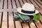 Straw hat and gloves on a garden table concept peace, finished work, gardening