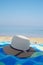 Straw hat on the sand near the shore on a beach in summer