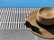 Straw hat and sunglasses along the poolside. Copy space. Summer concept. Sun protection. Beach style. Top view