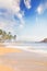 Straw hat, sunglasses, slippers and a bag on the golden sand of Sri Lanka`s beach