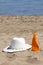 Straw Hat and Suntan Lotion on the Beach