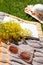 Straw hat, yellow wildflowers, open book, sunglasses on a brown knitted blanket on the lawn