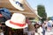 Straw hats stacked up for sale in a store street in shallow focus