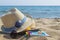 Straw hats, sunglasses and a book on the beach. Summer vacation