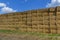 Straw or hay stacked in a field after harvesting. Straw bale wall.