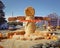 Straw man next to roadside pumpkin patch