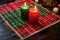 straw mat with red, green, black candles