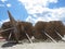 Straw Parasols Umbrellas Lying on Sandy Beach During Exotic Vacation