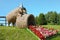 Straw pig sculpture and begonia flowers