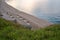 Straw sunshades and sunbeds on the empty sandy beach