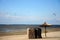 Straw umbrella and beach bed with kitesurfing