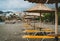 Straw umbrella on a sandy beach in Greece. Beach chairs with umbrellas on a beautiful beach in Crete island.