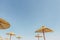 Straw umbrella or thatched hut with beautiful sky view on the tropical beach