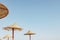 Straw umbrella or thatched hut with beautiful sky view on the tropical beach