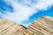 Straw umbrellas against blue sky