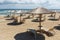 Straw umbrellas and beach chairs on the beach