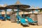 Straw umbrellas and deck chairs in a Red Sea beach - Marsa Alam Egypt Africa