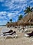 Straw Umbrellas And Sun Loungers in Riviera Maya