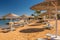 Straw umbrellas and sunbeds on the wonderful tropical beach.