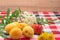 Strawberries, apricot, rowan flower, yellow dandelion lie on the table on the tablecloth