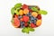 Strawberries, apricots, blueberries, peach in basket isolated on