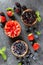 Strawberries, blueberries, blackberries tartlets with chocolate ganache, fresh berries and mint leaves. Fresh fruit tart, freshly