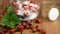 Strawberries in bowl on weight scale with sugar. leaf and flower head on wooden table. jam making