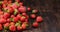 Strawberries in a bowl on a wooden dark table, selective focus. Close-up of ripe berries with copy space, idea for a banner.