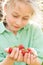 Strawberries in child\'s hands - fresh harvest from the garden