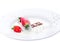 Strawberries and chocolate fall into organic milk, in a ceramic white plate. A spray of milk. Isolated, white background